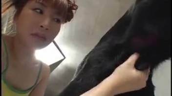 Asian redheaded whore blows two canines simultaneously