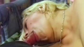 Naked blond woman captured on camera performing oral on a wet dog penis in super messy styles