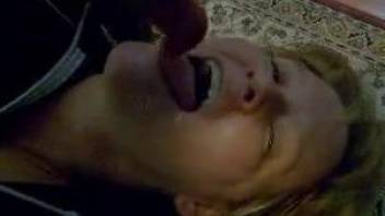 Mature moans with the dog cock in her mouth