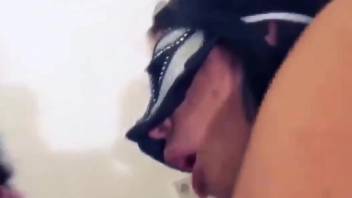 Brunette in a mask prepping to cum during hot oral