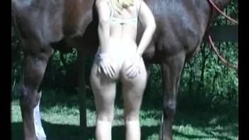 Blonde whore uses giant horse cock on her pussy